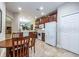 A practical kitchen boasts ample storage with wooden cabinets, white appliances and a cozy breakfast nook at 305 Bluewater Falls Ct, Apollo Beach, FL 33572