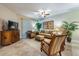 Cozy living room area with a ceiling fan, plush seating, and natural lighting at 305 Bluewater Falls Ct, Apollo Beach, FL 33572