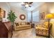 Cozy living room with neutral sofa, armchair, decorative accents and bright natural light at 305 Bluewater Falls Ct, Apollo Beach, FL 33572