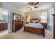 Charming main bedroom featuring a wooden sleigh bed, dresser, and calming decor at 305 Bluewater Falls Ct, Apollo Beach, FL 33572