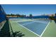 Community tennis courts with net and fencing offer an amenity for residents in a well-maintained complex at 305 Bluewater Falls Ct, Apollo Beach, FL 33572