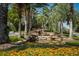 Beautiful water feature cascading down rocks, surrounded by manicured flowers and trees at 305 Bluewater Falls Ct, Apollo Beach, FL 33572