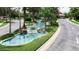 Scenic view of lush water feature surrounded by palm trees within the community at 305 Bluewater Falls Ct, Apollo Beach, FL 33572