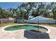 Spacious backyard featuring in-ground pool, brick patio, shed and mature trees at 3066 19Th Sw Pl, Largo, FL 33774