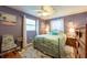 Cozy bedroom features a ceiling fan and two windows for natural light at 3066 19Th Sw Pl, Largo, FL 33774
