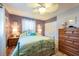 Comfortable bedroom with ceiling fan, wood floors, and closet at 3066 19Th Sw Pl, Largo, FL 33774