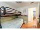 Bedroom featuring bunk beds and wood laminate flooring at 3066 19Th Sw Pl, Largo, FL 33774