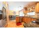 Kitchen with stainless steel appliances and wooden cabinets, opens to dining area at 3066 19Th Sw Pl, Largo, FL 33774