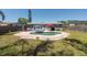 Backyard pool with a brick surround, deck area, and adjacent outdoor seating at 3066 19Th Sw Pl, Largo, FL 33774