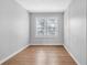 Empty bedroom featuring wood flooring, a window and neutral-colored walls at 3409 N 10Th St, Tampa, FL 33605