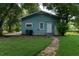 Charming blue home featuring a well-manicured lawn and inviting walkway at 3409 N 10Th St, Tampa, FL 33605