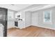 Clean kitchen with modern appliances, white cabinetry, wooden floor, and a view to the outdoor at 3409 N 10Th St, Tampa, FL 33605
