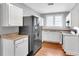 White kitchen with updated countertops, new cabinets, stainless steel appliances, and wood flooring at 3409 N 10Th St, Tampa, FL 33605