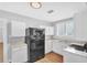 Bright kitchen featuring white cabinets, modern appliances, granite countertop, and light wood floor at 3409 N 10Th St, Tampa, FL 33605