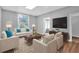 Bright living room featuring stylish furniture, a large window, and hardwood flooring at 3409 N 10Th St, Tampa, FL 33605