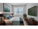 Comfortable main bedroom with a large bed, a big window, and a TV at 3409 N 10Th St, Tampa, FL 33605