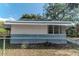 Exterior side of house with secure chain link fence and tree, well-maintained side lawn at 3409 N 10Th St, Tampa, FL 33605
