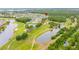 Aerial view of the community, featuring a golf course, ponds, and lovely homes at 3503 Gaviota Dr, Sun City Center, FL 33573