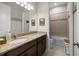 Bathroom featuring granite counters, vanity, large mirror, and shower-over-tub at 3503 Gaviota Dr, Sun City Center, FL 33573