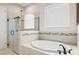 Bathroom featuring a frameless glass shower and a relaxing soaking tub at 3503 Gaviota Dr, Sun City Center, FL 33573
