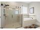 Bathroom featuring a frameless glass shower and a relaxing soaking tub at 3503 Gaviota Dr, Sun City Center, FL 33573