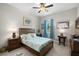 Well-lit bedroom featuring a ceiling fan, a comfortable bed with stylish linens, and side tables at 3503 Gaviota Dr, Sun City Center, FL 33573