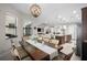Bright dining room featuring a modern light fixture, dining table, and an open-concept design connecting to the kitchen and living areas at 3503 Gaviota Dr, Sun City Center, FL 33573