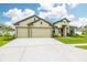 Inviting single-story home featuring a three-car garage and manicured lawn with excellent curb appeal at 3503 Gaviota Dr, Sun City Center, FL 33573