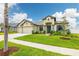 Inviting single-story home showcasing a well-manicured lawn, charming landscaping, and a convenient three-car garage at 3503 Gaviota Dr, Sun City Center, FL 33573