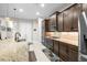 Gourmet kitchen featuring stainless steel appliances, granite countertops, and wood cabinetry at 3503 Gaviota Dr, Sun City Center, FL 33573