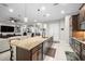 Open-concept kitchen with stainless appliances, bar seating, and adjacent dining and living areas at 3503 Gaviota Dr, Sun City Center, FL 33573