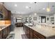 Modern kitchen with a large island and seating, seamlessly connected to the dining and living areas at 3503 Gaviota Dr, Sun City Center, FL 33573