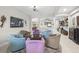 Cozy living room features a unique seating area, neutral walls, and seamless connectivity to other living spaces at 3503 Gaviota Dr, Sun City Center, FL 33573
