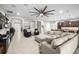 Spacious living room featuring a large sectional sofa and an eye-catching ceiling fan at 3503 Gaviota Dr, Sun City Center, FL 33573