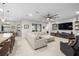 Well-lit living room with a modern sectional sofa and adjacent kitchen with barstool seating at 3503 Gaviota Dr, Sun City Center, FL 33573