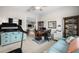 Home office featuring a treadmill, desk, blue couch, and ample workspace at 3503 Gaviota Dr, Sun City Center, FL 33573