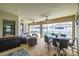 Relaxing screened patio with dining table, ceiling fans, and comfortable wicker seating area at 3503 Gaviota Dr, Sun City Center, FL 33573