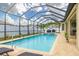 Beautiful screened pool area with outdoor seating and lush landscaping at 3503 Gaviota Dr, Sun City Center, FL 33573