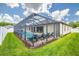 A spacious screened-in pool area with lounge chairs and manicured lawn at 3503 Gaviota Dr, Sun City Center, FL 33573