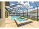 Inviting pool and spa with screened enclosure, surrounded by a tiled patio at 3503 Gaviota Dr, Sun City Center, FL 33573