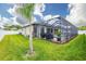 Landscaped backyard with a screened pool and patio area at 3503 Gaviota Dr, Sun City Center, FL 33573