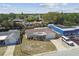 Aerial view of single-story home with a one car garage, driveway, and neighboring buildings at 3514 Truman Dr, Holiday, FL 34691