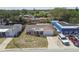 Aerial view of single-story home with a one car garage, driveway, and neighboring buildings at 3514 Truman Dr, Holiday, FL 34691