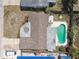 Aerial view of a single-Gathering home, pool, patio area, brown shingle roof, and manicured landscaping at 3514 Truman Dr, Holiday, FL 34691