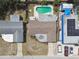 Aerial view of home with a pool, one car garage, driveway, and neighboring buildings at 3514 Truman Dr, Holiday, FL 34691
