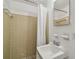 Bathroom features a shower with tan tiles, toilet, sink, and a mirror at 3514 Truman Dr, Holiday, FL 34691