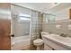 Bathroom with a tub and shower, white toilet, and a sink with a vanity mirror at 3514 Truman Dr, Holiday, FL 34691