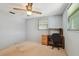 Bedroom boasts neutral walls, carpet floors, ceiling fan, and built-in desk with storage at 3514 Truman Dr, Holiday, FL 34691
