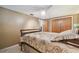 Comfortable bedroom with patterned bedding, ceiling fan, and closet space at 3514 Truman Dr, Holiday, FL 34691