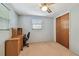 This bedroom includes a closet, ceiling fan, carpet, and built-in desk at 3514 Truman Dr, Holiday, FL 34691